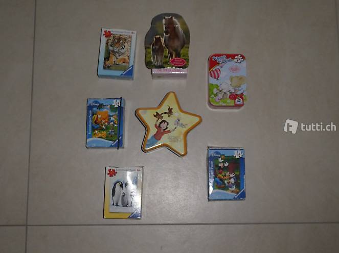 Kleine Puzzle gem. Foto, zwei in Blechdose