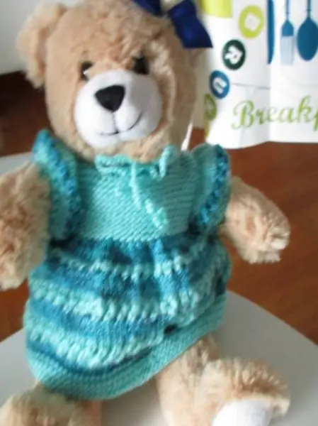 Neuer Teddybär mit neuem Häkelkleid grüntürkis